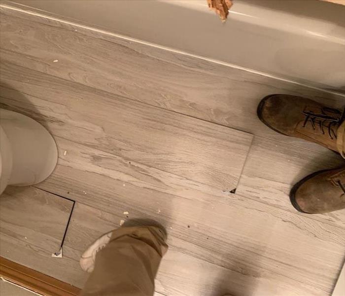 ruined bathroom floor near a toilet 
