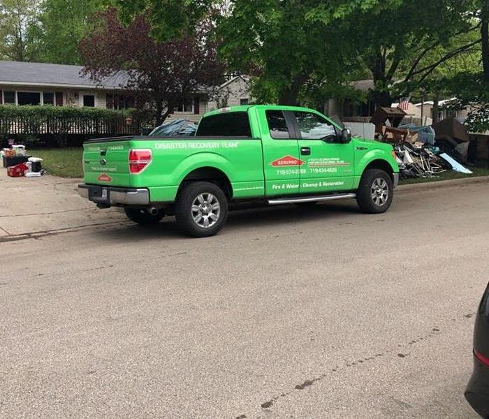 SERVPRO truck parked outside home.