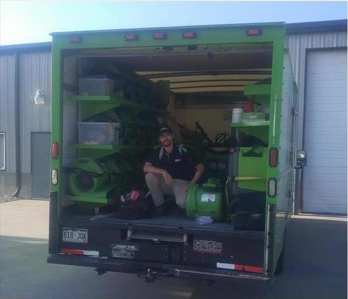 Servpro worker inside a truck equipped with drying machinery